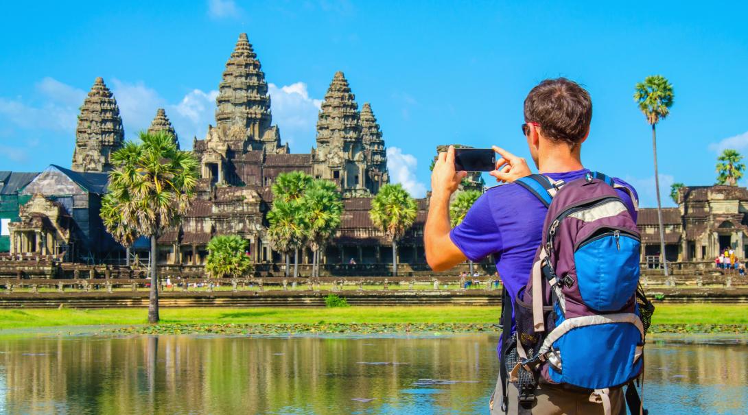 Projects Abroad volunteer explores Cambodia during his free time. Traveller takes a photo of Angkor Wat during his travels through Cambodia.